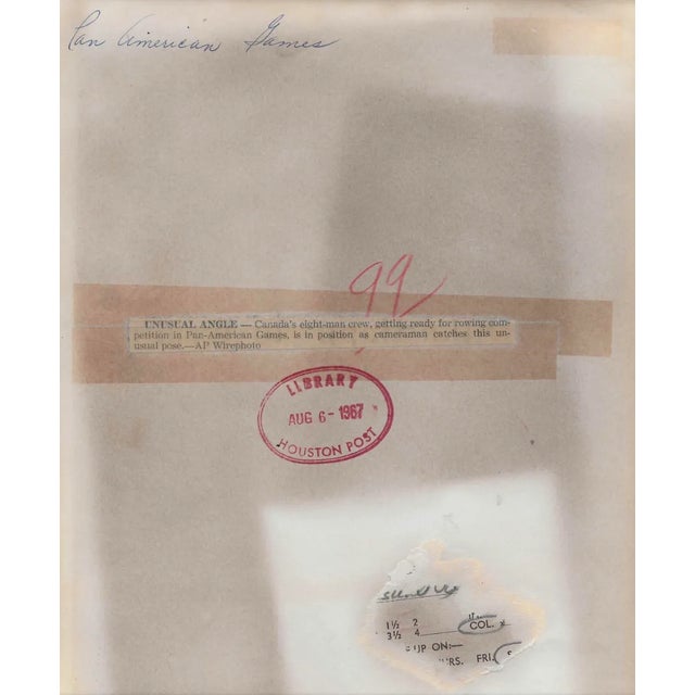 1967 black & white photo of Canada's eight man rowing team at a Pan American Games race. Publication information on the back.