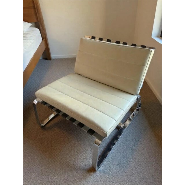 Minotti Deluanay Lounge chair is designed by Rudolfo Dordoni. The chair is constructed with brown leather strapping and...