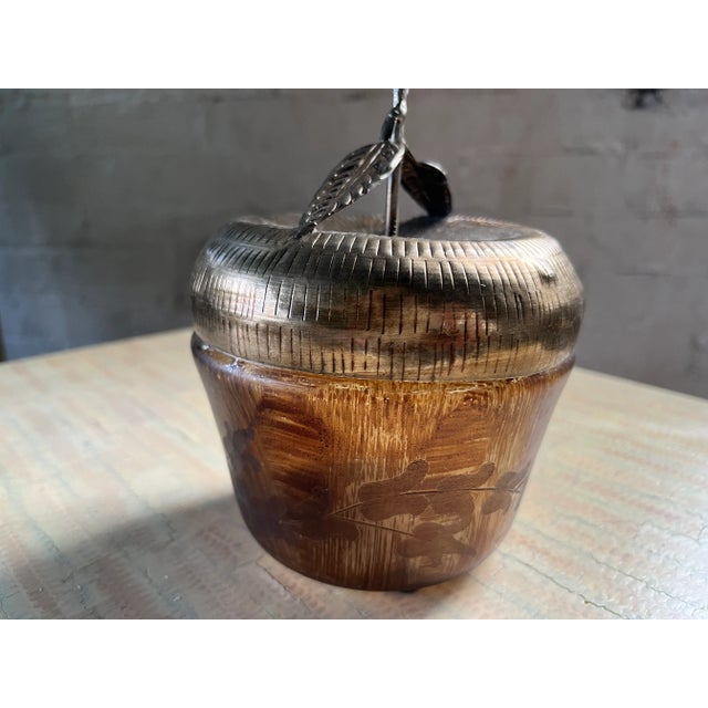 This vintage decorative catchall features a unique apple-shaped design with a warm, wood-toned body and a silver-toned...