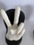 A bold pair of vintage 1970s novelty bookends featuring sculptural hands — one flashing a peace sign, the other a raised...