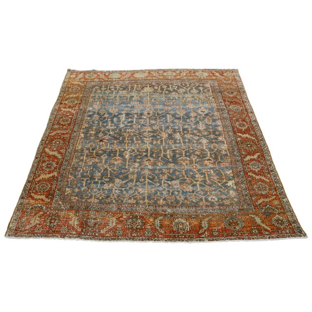This antique Persian Heriz rug is made with hand-knotted wool. The blue field showcases a captivating allover pattern with...