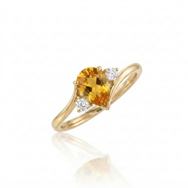 Bring a touch of warm, sun-kissed brilliance to your jewelry collection with this stunning pear-cut bypass ring. At its...