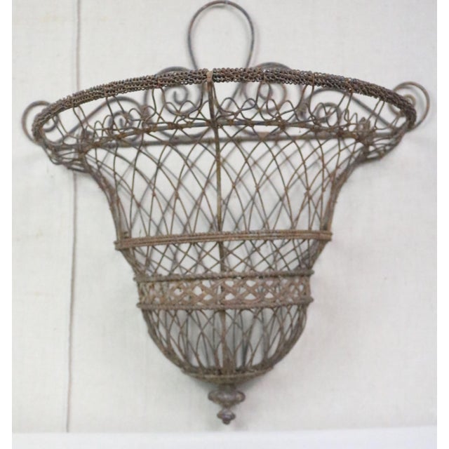 An unusual mid 19th century French wire hanging planter. It is in classic Napoleon III style and retains remnants of its...
