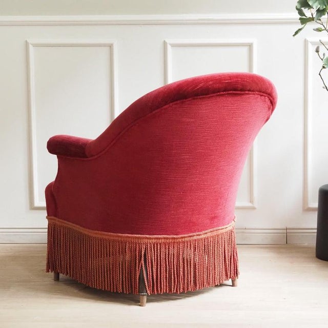 This fully upholstered cocktail chair can be stylistically dated to the mid-20th century, around 1950. The elegant,...