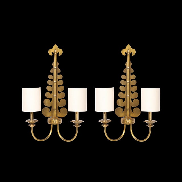 This sculptural Pair of Mid-Century Brass Two-Arm Sconces w/ Sculptural Volute Motif originated in Spain, 20th Century....