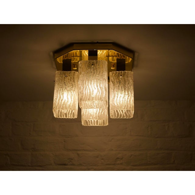 Ceiling light with octagonal base in solid brass, with 4 lights covered with “ice glass” effect murano glass globes....