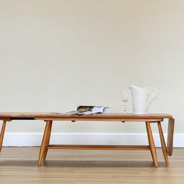 An original extending coffee table designed by Lucian Ercolani and handcrafted by Ercol in England during the 1960s....