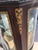 An antique French Louis XV style display vitrine with single door opening to shelved interior, bronze ormolu and raised on...