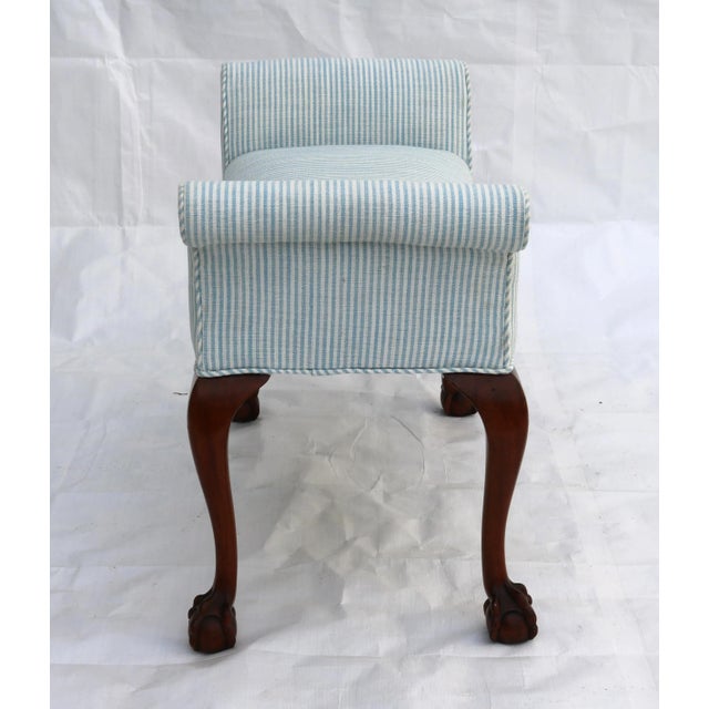 Stunning window/foot of bed bench with carved mahogany ball and claw feet with blue and white piped upholstery seat. I...