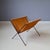 This magazine holder from the 50s/60s features a foldable black metal frame and a rust brown leather (suede) sling. In...