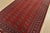 A tribal Bokhara rug hand-knotted with fine wool on a cotton foundation. This rug features rows of repeating medallions...