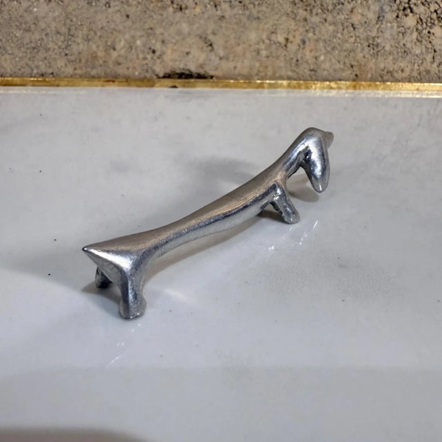 For your consideration, a set of five (5) Italian vintage silver-plated (or aluminum) dachshund dog knife rest. Unmarked....