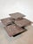 A rare and sculptural set of four granite nesting tables, designed as a modular composition. Each table features a solid...