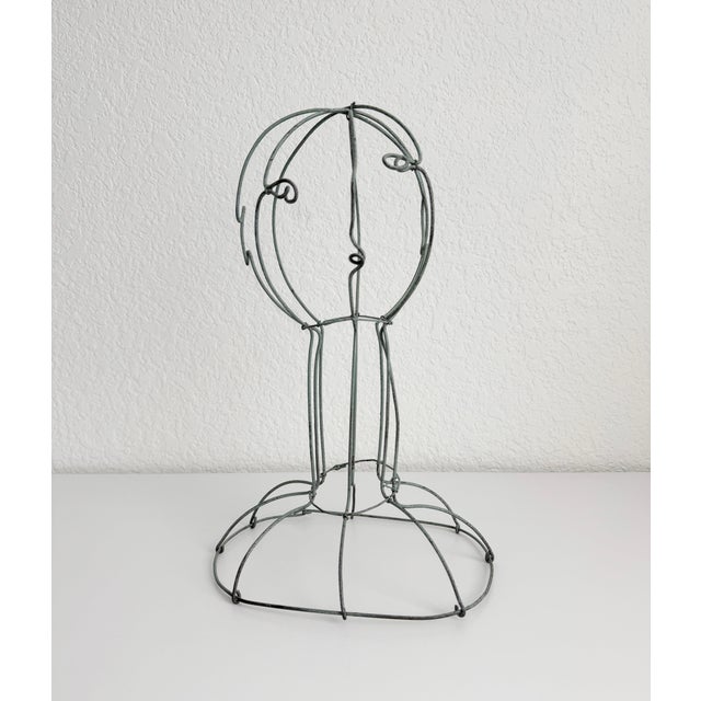 Late 20th century, verdigris-finish metal wire female figure sculpture or bust with a flared base and open, hand-formed...