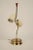 This delicate, humorful table lamp from Austria dates circa 1950s. Made of brass with off white colored shades and a...