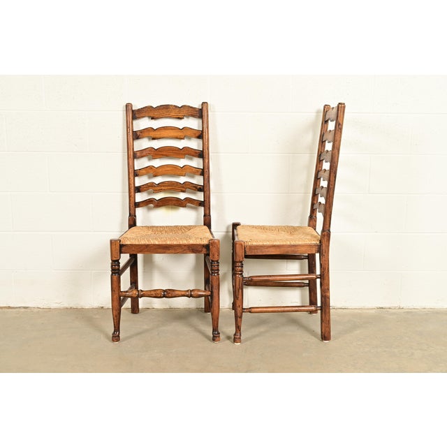 Baker Furniture Style English Country Rustic Carved Solid Oak Ladder Back Dining Chairs With Rush Seats, Pair For Sale - Image 11 of 13