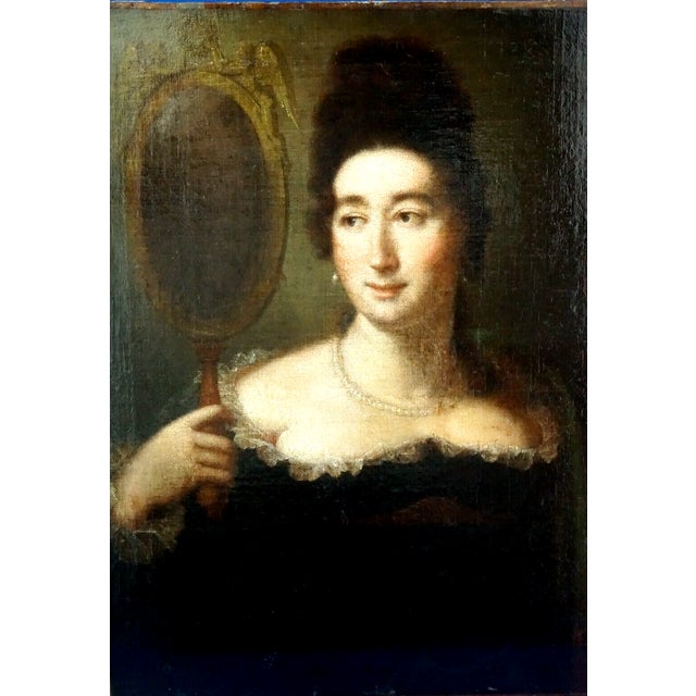 Beautiful 18th-century oil on canvas painting depicting a lady looking at herself in a hand mirror, created in France....