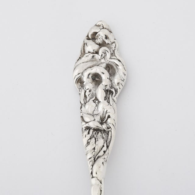 This finely crafted antique Dutch silver oval spoon serves as a functional yet decorative piece, designed for elegantly...