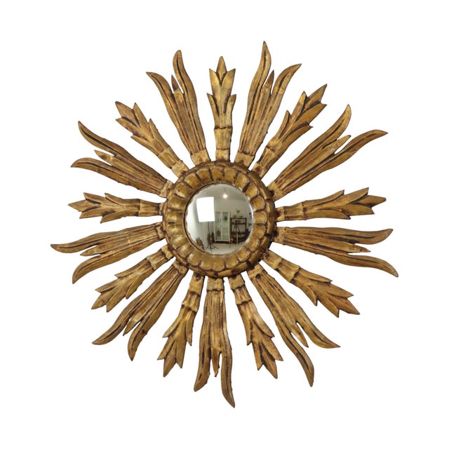 Beautiful old sunburst mirror with convex glass and a frame made of carved and gilded wood, Spanish in origin,...