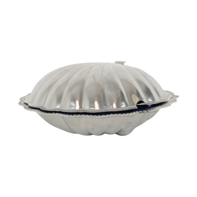 Vintage chrome-plated metal butter dish/caviar holder shaped like a shell, featuring a blue pressed-glass insert and a...