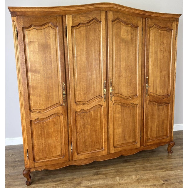 A beautiful Vintage French Louis oak wardrobe , showcasing elegant curves, classic panelled doors, and refined...