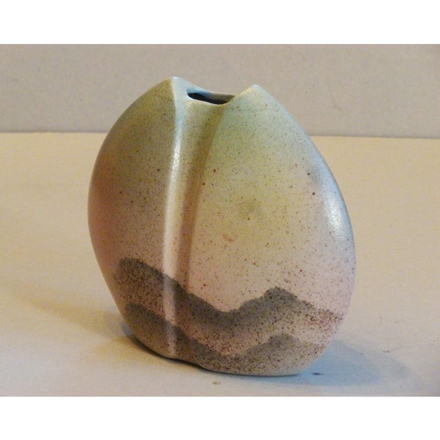A lentil-shaped porcelain vase by Virebent, dating from the 1970s/80s, with a grainy, matte finish and a stylized...