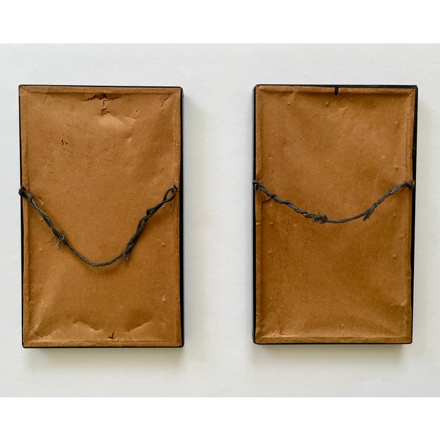 A pair of framed silhouettes from the 1930s depict the profile of a young boy and a full length profile of a young girl....