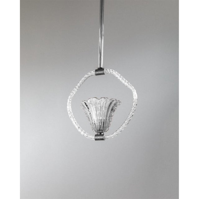 This rare and really long vintage Murano glass chandelier was designed by Barovier e Toso in the 1940s and embodies the...