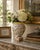 A richly decorated neoclassical faience vase painted with classical putti, scrolling acanthus foliage, garlands, and...