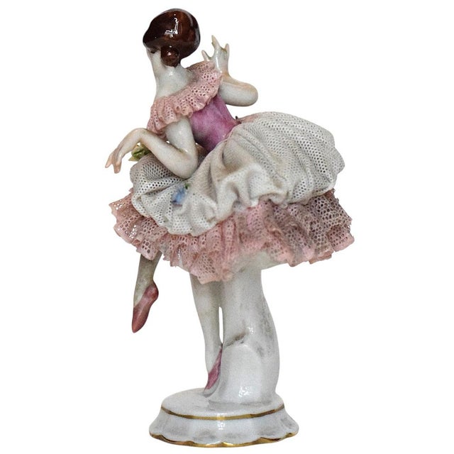 A delicate porcelain figurine depicting a ballerina in a dancing pose, crafted with exceptional attention to detail. The...