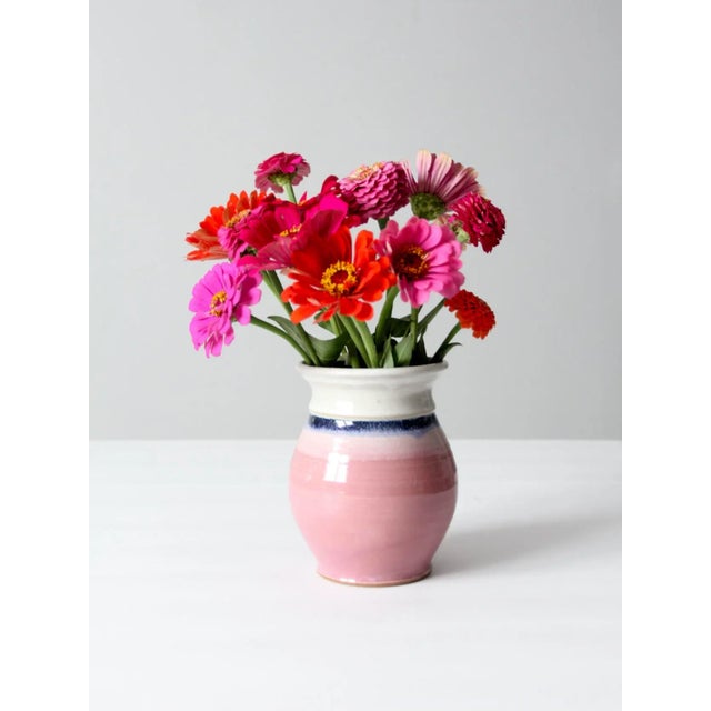Handcrafted vintage studio pottery vase with a sculptural, bulbous silhouette and an artful presence. Finished in a soft...