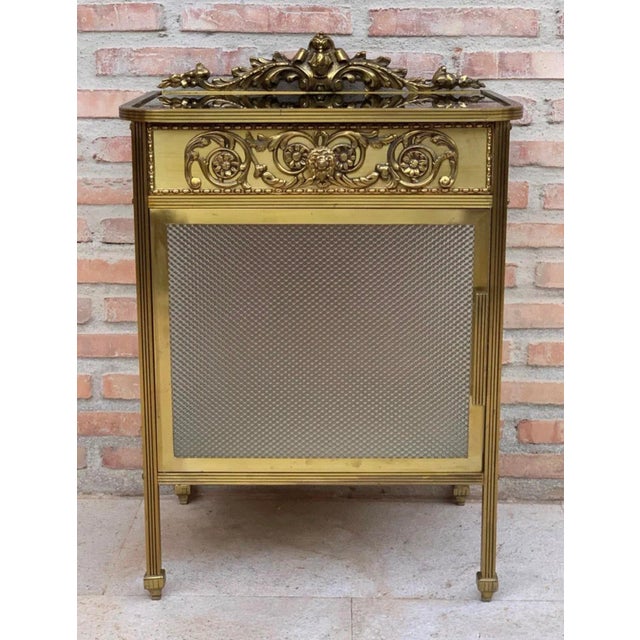 20th century single bronze nightstand with glass door and drawers. this bronze or glass vitrine cabinet or nightstand is...