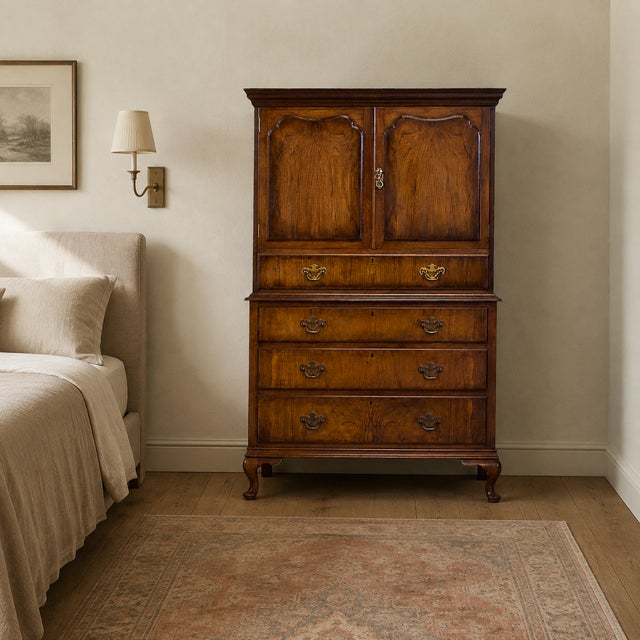 A fine 1930s burr walnut cabinet on chest by Waring & Gillow, retaining its original maker’s label. Two panelled doors...
