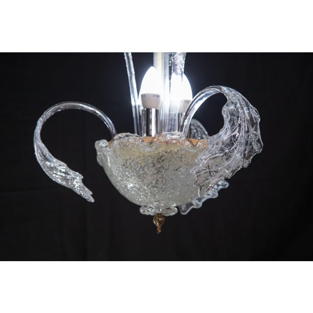 Delightful transparent Murano chandelier made up of three high leaves and three low leaves. The chandelier is 100...