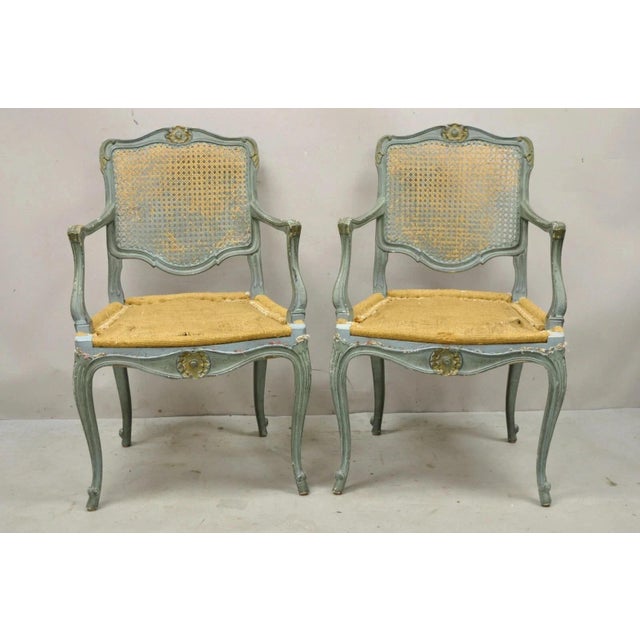 Antique French Louis XV Style Blue Painted Cane Back Fauteuil Arm Chairs - a Pair. Item features solid wood frames,...