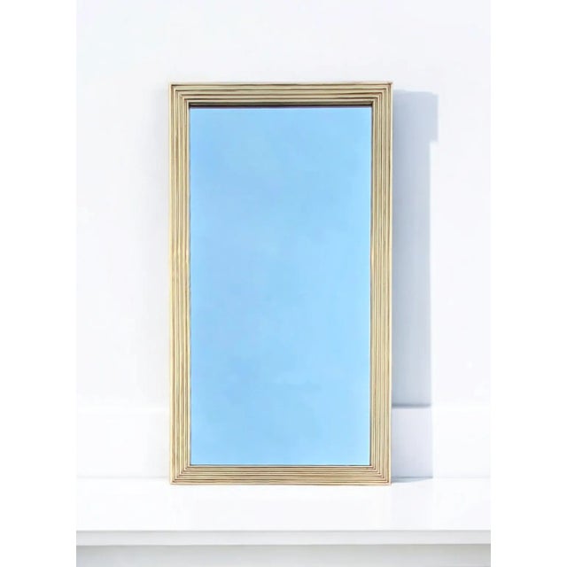 This 19th Century French Reeded Brass Frame Mirror has elegant neoclassical symmetry while also strikingly modern. Mirror...