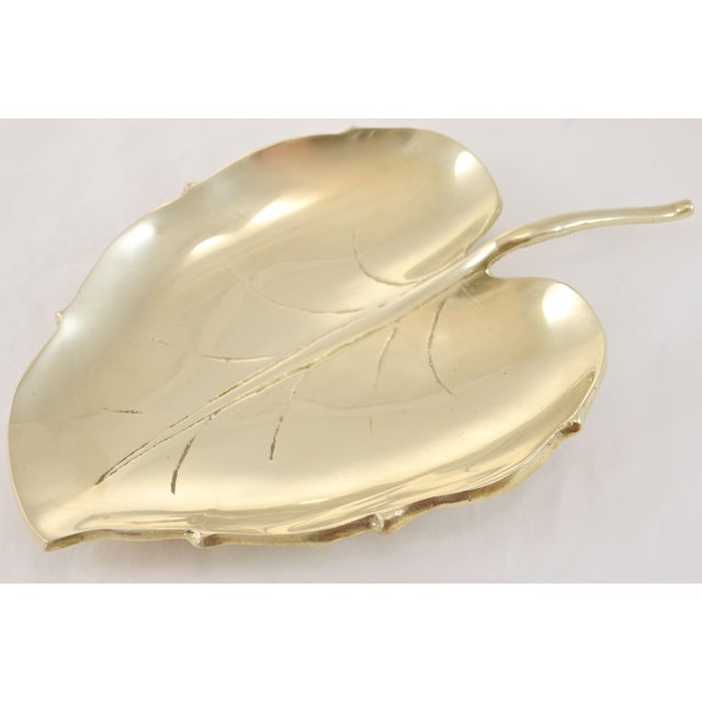 Large vintage solid cast brass leaf with engraved veins and a stem handle. Use as an entryway catchall dish or coffee...