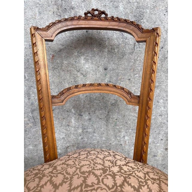 These pair of antique hand-carved French side chairs with Fortuny style upholstered seats exude elegance and...