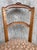These pair of antique hand-carved French side chairs with Fortuny style upholstered seats exude elegance and...