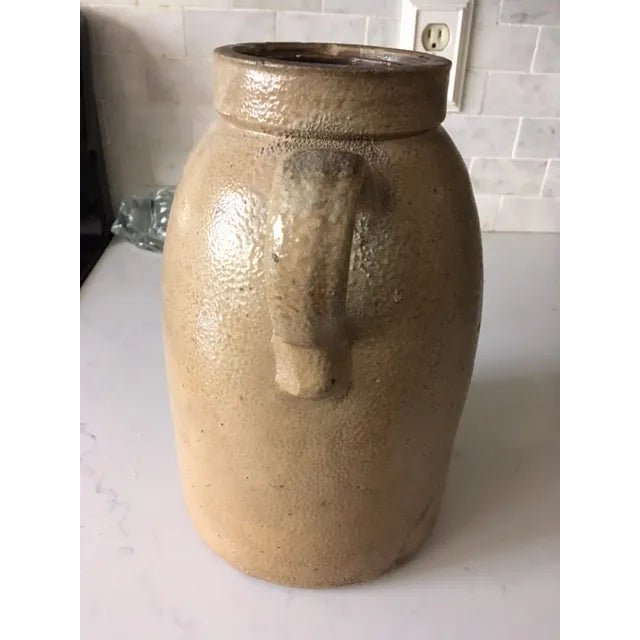 This is a very nice antique apple glazed stoneware crock/jug. The blue design on the front represents apples; thus it is...