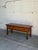 This exceptional entry bench displays a striking linear profile accented by an architectural, textured block front design....