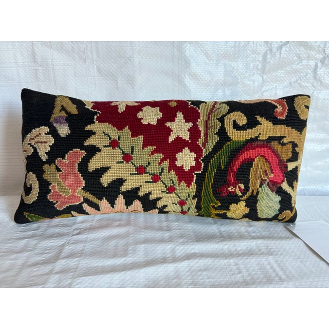 Add classic charm to your space with the English Needlework Pillow, measuring 17" x 8". This intricately crafted piece...