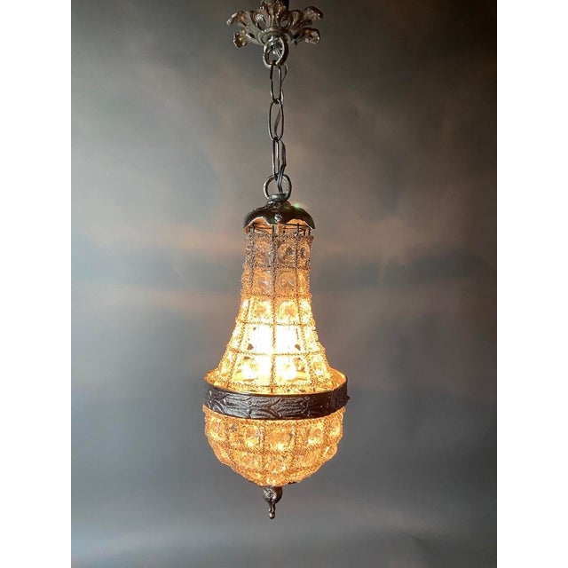 A refined 1980s French Louis XVI-style basket chandelier, beautifully crafted in bronze with an elegant silver-toned...