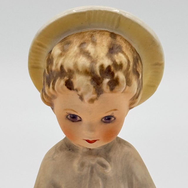 A sweet and devotional German porcelain figurine titled “Christchild with Holly.” Featuring soft hand-painted features, a...