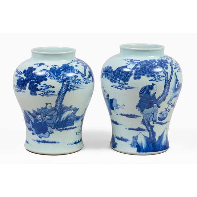 Near pair of large Chinese blue and white baluster vases decorated with figures relaxing in a landscape of dragon-like...
