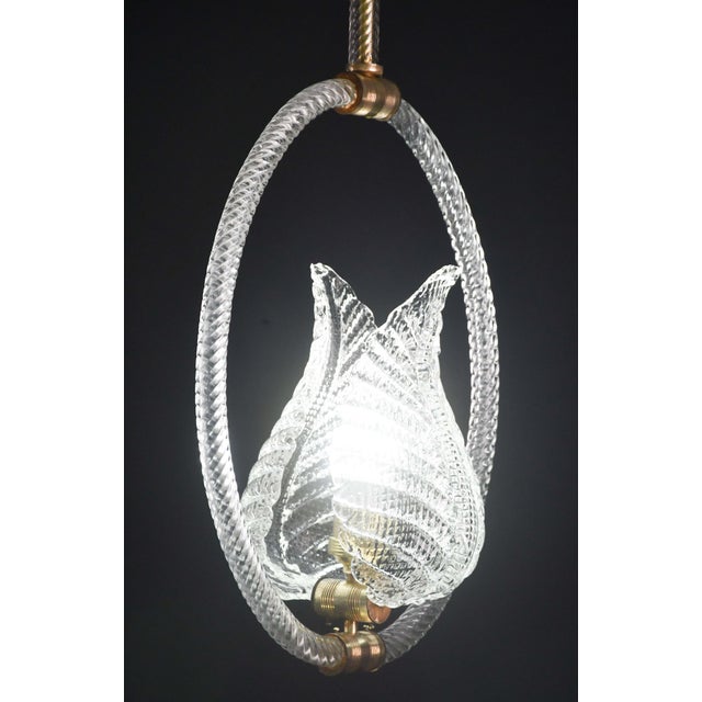 Stunning Murano chandelier by artist Ercole Barovier. The pendant consists of 6 glass elements and a brass structure. It...