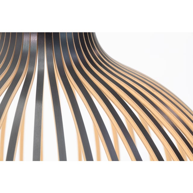 A contemporary modern Victo 4250 light fixture by Secto Design. This stunning modern light fixture duals as a sculptural...