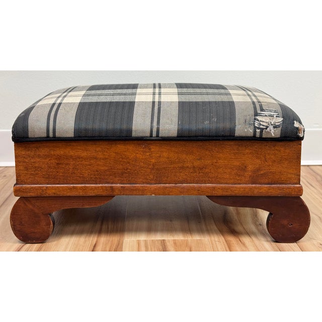 Antique Early American footstool ottoman featuring original gray and ivory plaid upholstery. Hinged lid for storage....