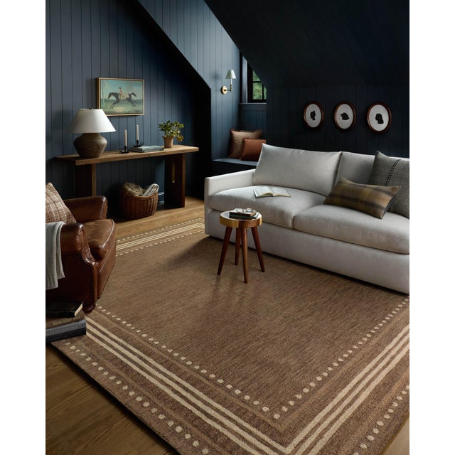 The Alfie Collection from Chris Loves Julia x Loloi is a handmade area rug with a playful framed design, a modern update...