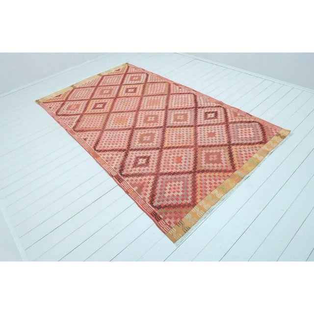 This beautiful, vintage, handwoven kilim rug is approximately 60 years old. It is handmade of hand spun wool in all...